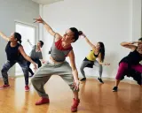 Grupa kobiet tańczy w rytm muzyki. To właśnie salsation – połączenie tańca i treningu.